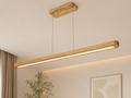 UNIKAA modern linear wooden pendant light for office space displayed in a minimalist premium interior with soft neutral background styling.