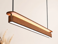 UNIKAA modern linear wood pendant light for reception counter installed in a premium interior creating warm ambient lighting