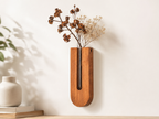 Close-up of Unikaa solid wood wall vase with removable glass tube holding dried flowers for minimalist home decor.